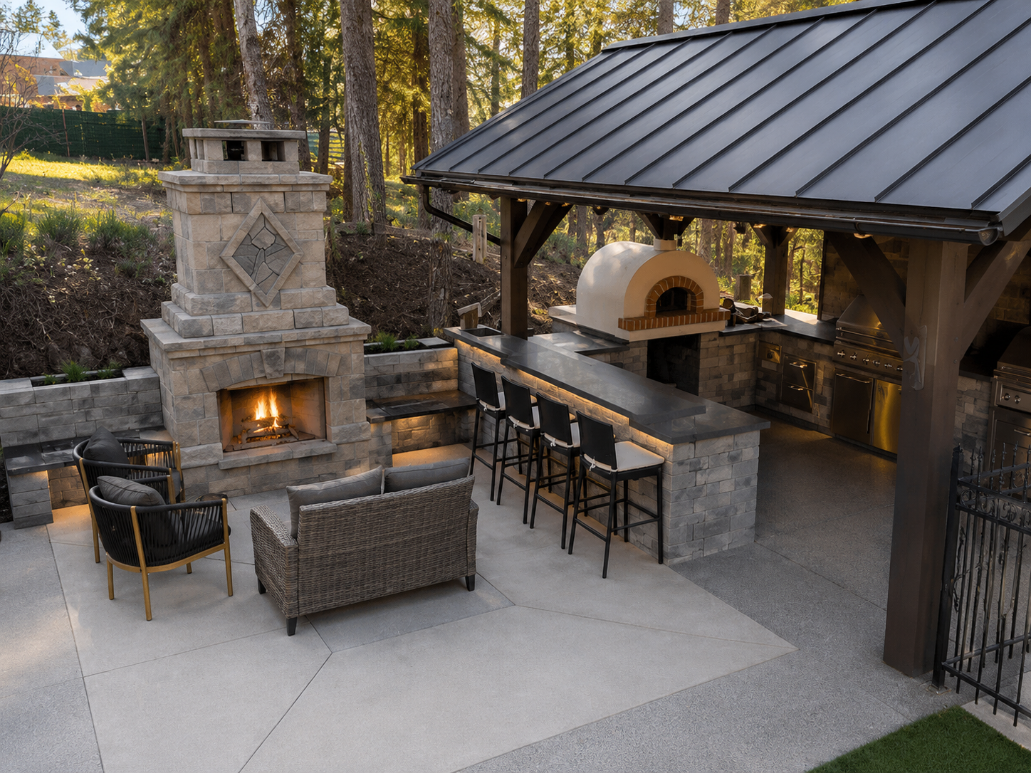 Outdoor kitchen and bar seating area with fire feature