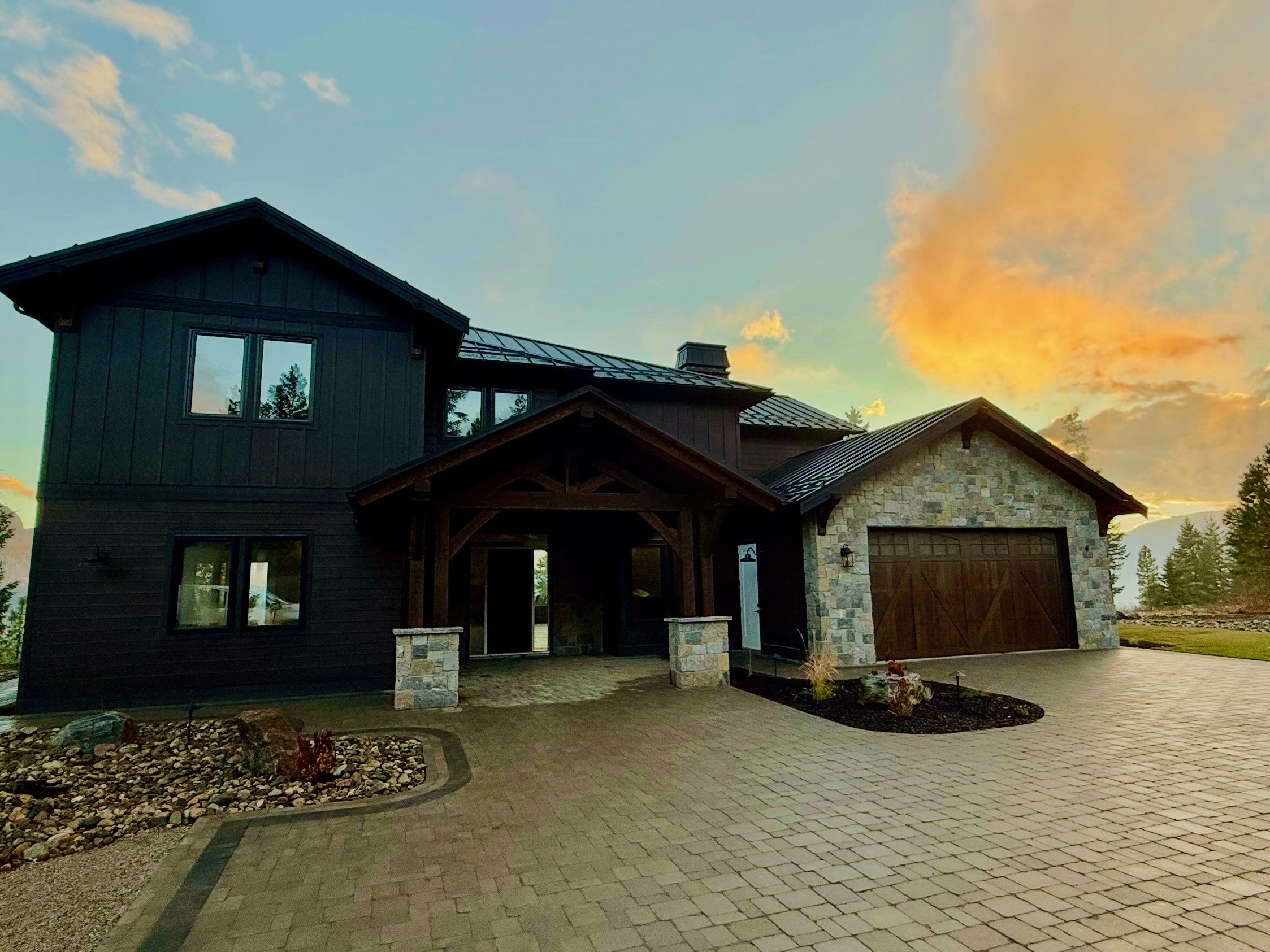 Curving paver walkway connecting a front entry through landscaped beds in the Okanagan