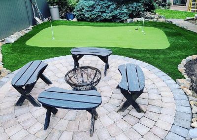 Kalagan Outdoor Design putting green near patio chairs