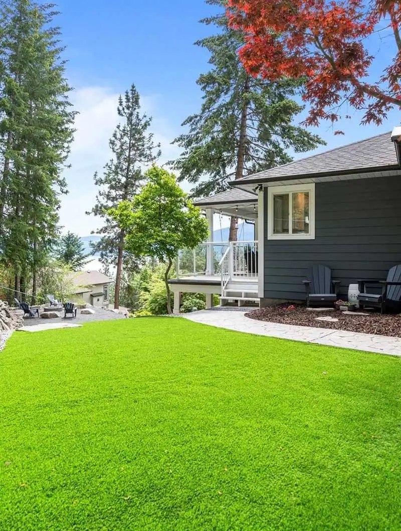 Kalagan astroturf and rock wall next to blue house